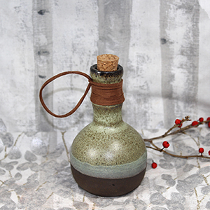 A green ceramic bottle