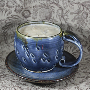 An ultramarine purple mug full of potato soup